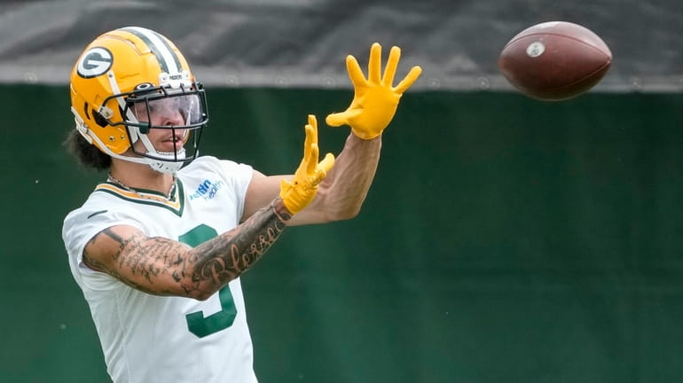 Green Bay Packers' Christian Watson catches a pass during an...