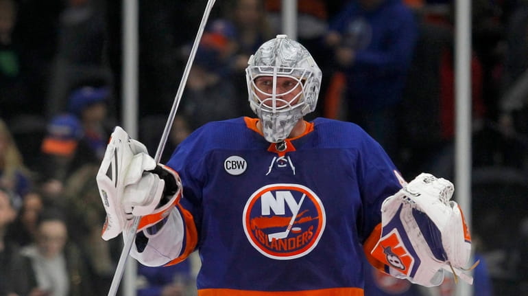 Robin Lehner #40 of the Islanders celebrates after defeating the...