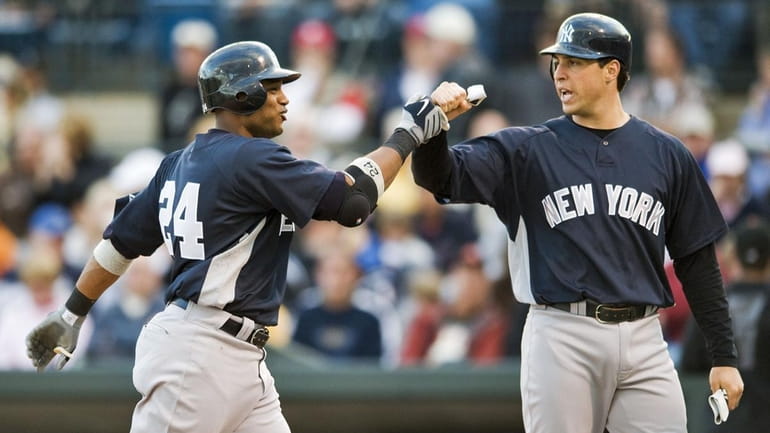 New York Yankees' Mark Teixeira, right, greets Robinson Cano at...