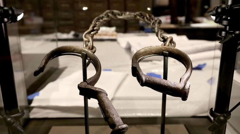 A pair of slave shackles are on display in the...