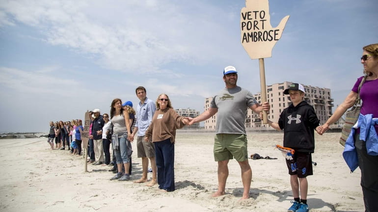 Hands Across the Sand demonstrators line up across the beach...