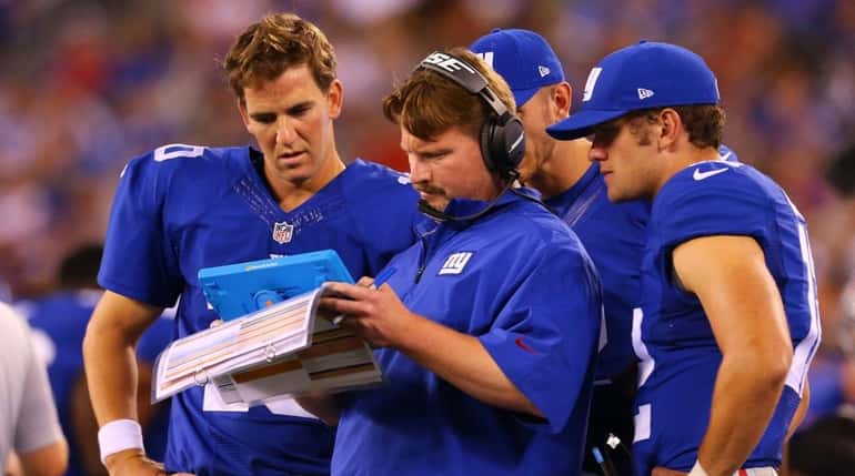 New York Giants quarterback Eli Manning and offensive coordinator Ben...