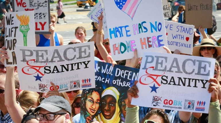 Protesters listen during a "Peace and Sanity" rally Sunday Aug....