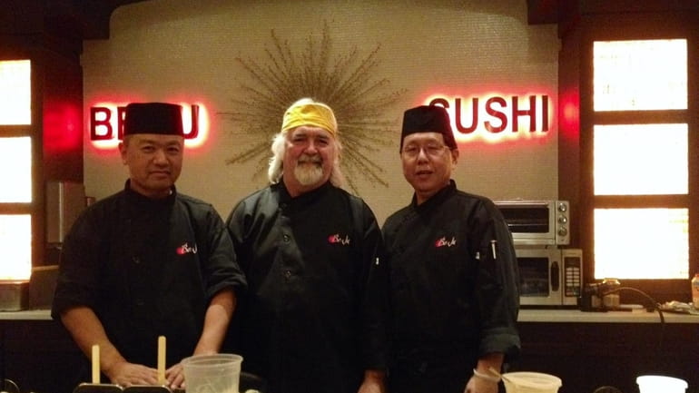 Sushi chefs Shigeki Uchiyama, left, and Hiroki Tanii flank Tom...