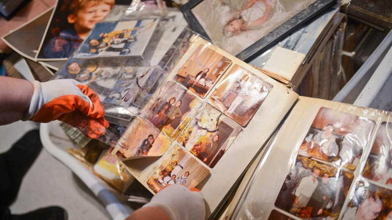 Sandy Durando looks through her albums for salvageable family photographs...