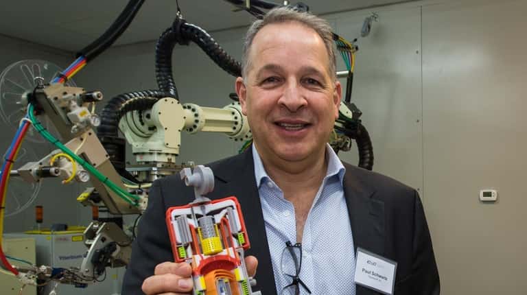 Paul Schwartz, CEO of ThermoLift, holds a protype of the company's heat...