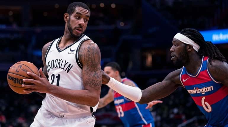 Nets center LaMarcus Aldridge, left, is defended by Wizards center...