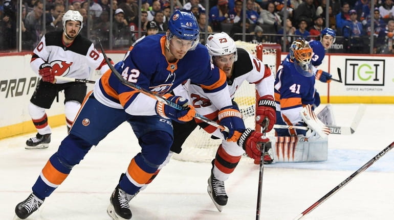 New York Islanders defenseman Scott Mayfield chases the puck against...