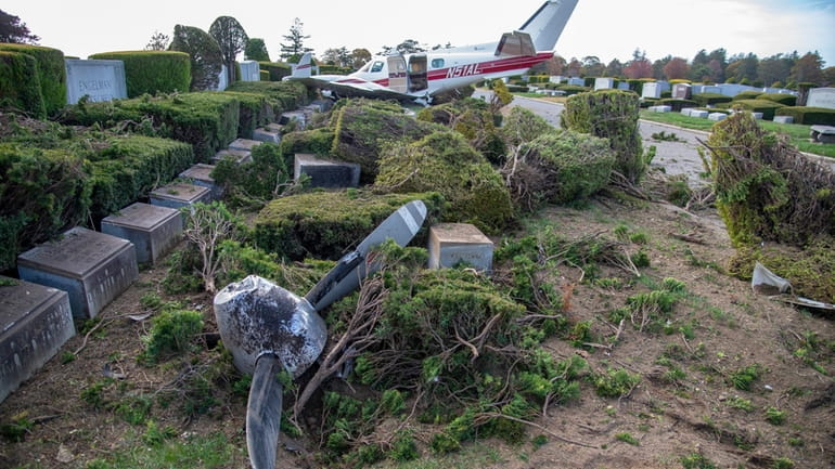 A Beech B-60 plane came to a stop among gravestones...