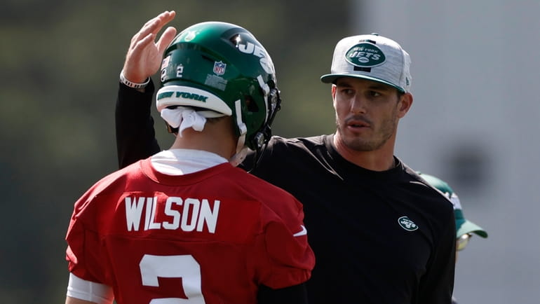 Jets QB Zach Wilson talks to quarterbacks coach Rob Calabrese at...