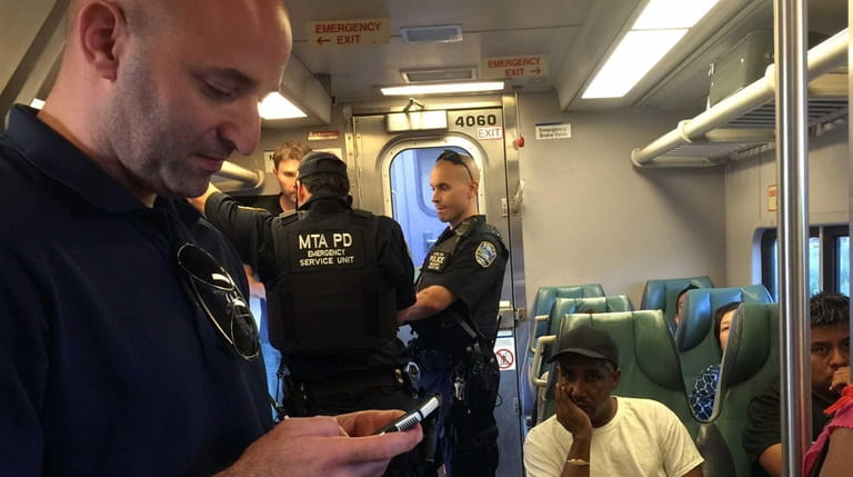 Members of the MTA Police Department's Emergency Service Unit wait...