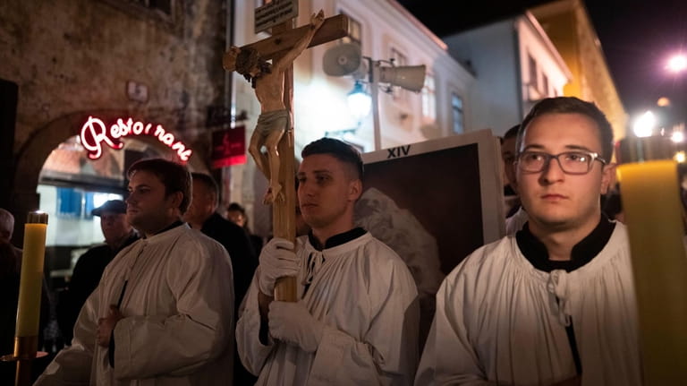 Men wearing altar-boy robes take part in a pro-life march...