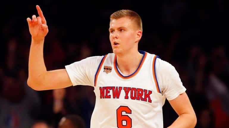 Knicks forward Kristaps Porzingis reacts after hitting a three-pointer during...