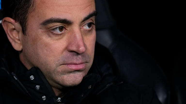 Barcelona's head coach Xavi Hernandez looks out from the bench...