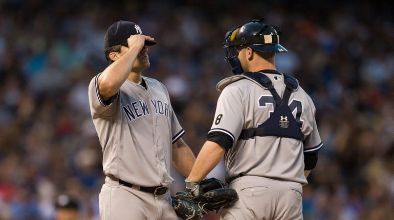 Brian McCann visits Yankees starter Nathan Eovaldi during the fifth...