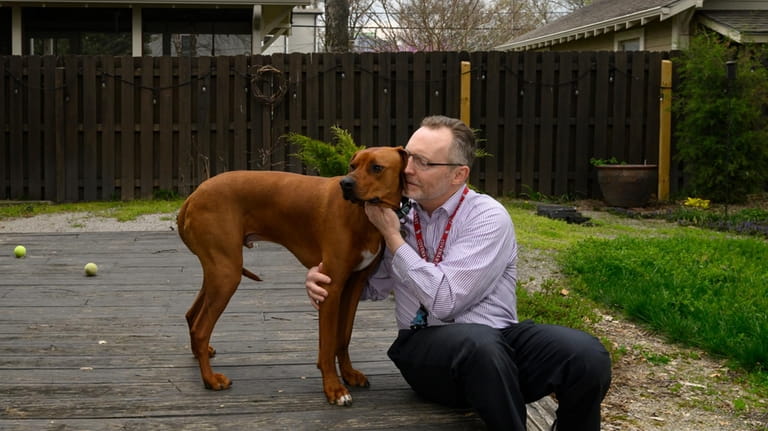 Chaplain Matthew Sullivan spends time with his dog Hank after...