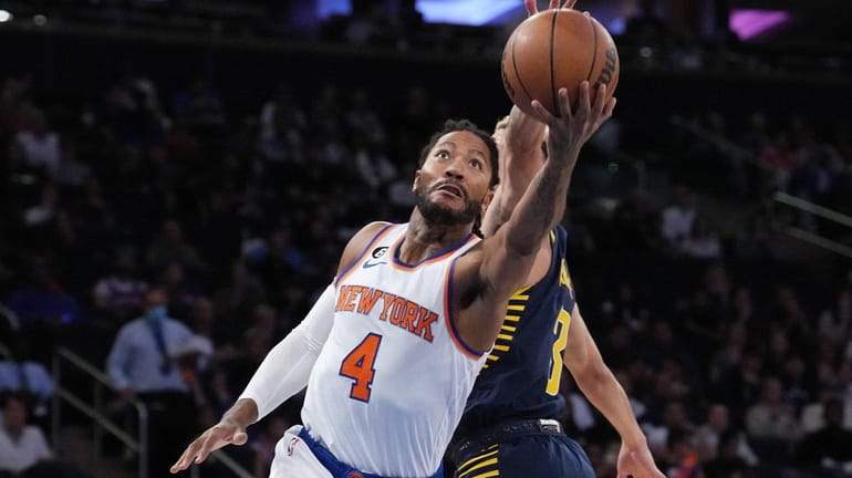 Derrick Rose of the Knicks drive to the basket against...