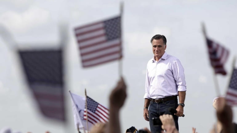 Republican presidential candidate Mitt Romney appears on stage during a...