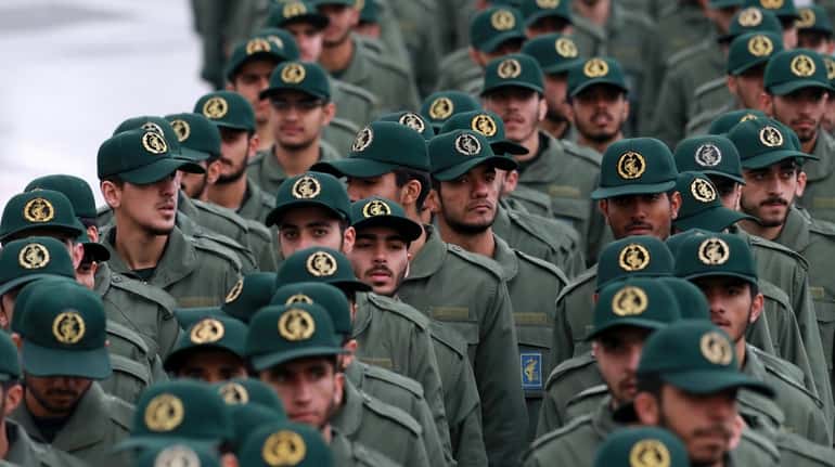 Iranian Revolutionary Guard members arrive for a ceremony celebrating the...