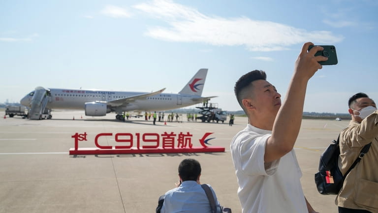 In this photo released by Xinhua News Agency, a passenger...