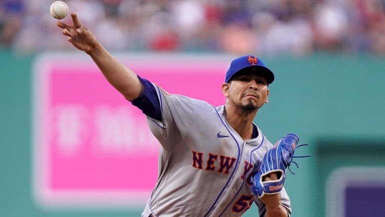 New York Mets' Carlos Carrasco delivers a pitch to a...