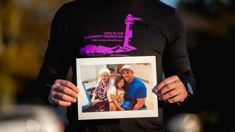 Jay Asparro holds a photo that includes his grandmother Ann Asparro,...
