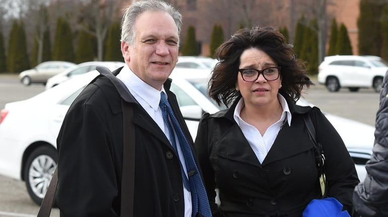 Edward and Linda Mangano leave federal court in Central Islip...