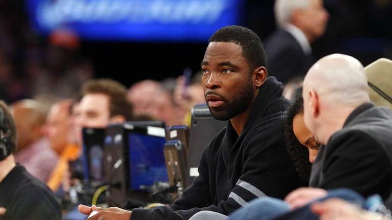 Justin Tuck attends a game between the New York Knicks...