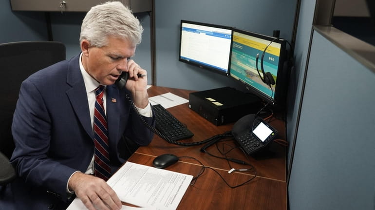 Suffolk County Executive Steve Bellone answers a call at the Suffolk...