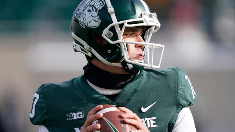 Michigan State quarterback Payton Thorne warms up before the first...