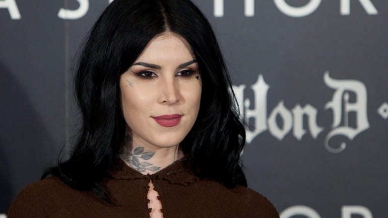 Tattoo artist Kat Von D poses for photographers during the...