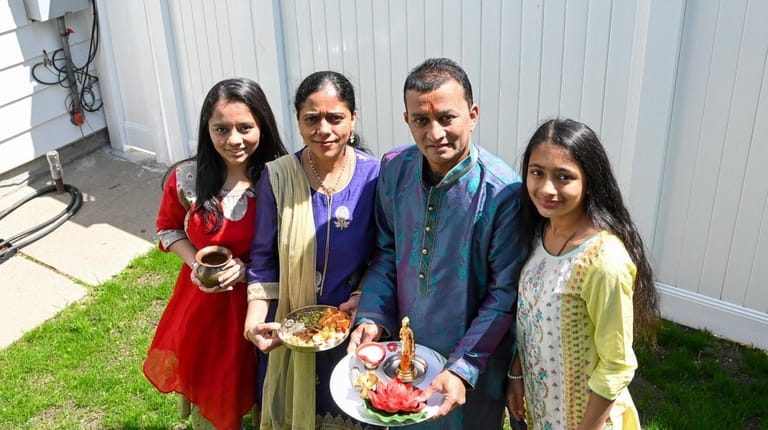 Pinal and Vivek Patel with their daughters Gayatri, 19, left, and...