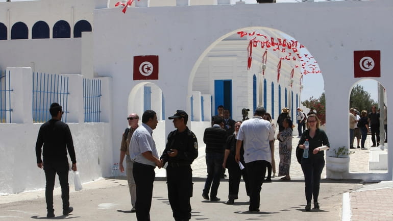 A Tunisian police officer stands at the entrance at El-Ghriba...