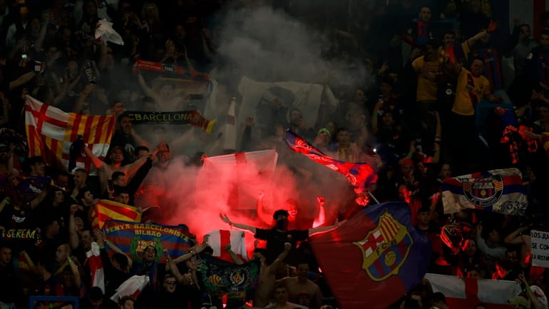 Barcelona supporters celebrate at the end of the Champions League...