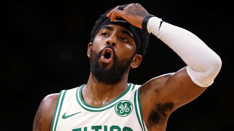 Celtics guard Kyrie Irving reacts during the first quarter of...
