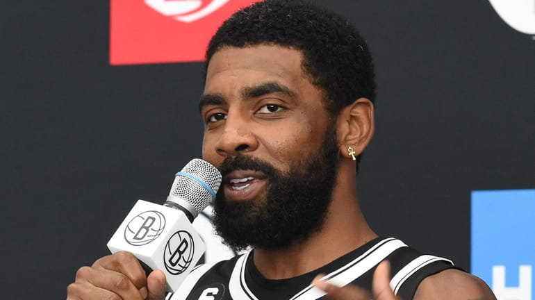 Kyrie Irving of the Brooklyn Nets fields questions from reporters during...