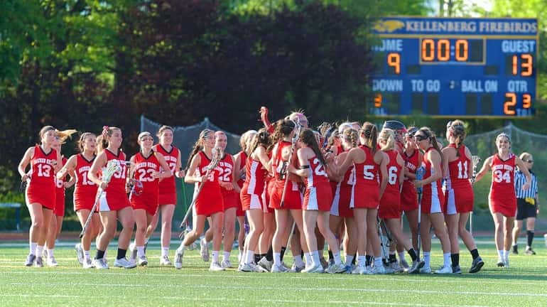 Sacred Heart celebrates at midfield after defeating Kellenberg in the...