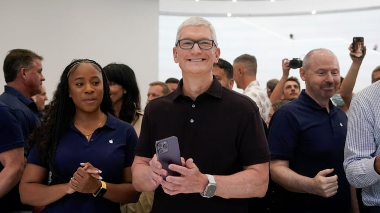 Apple CEO Tim Cook smiles at an Apple event in...