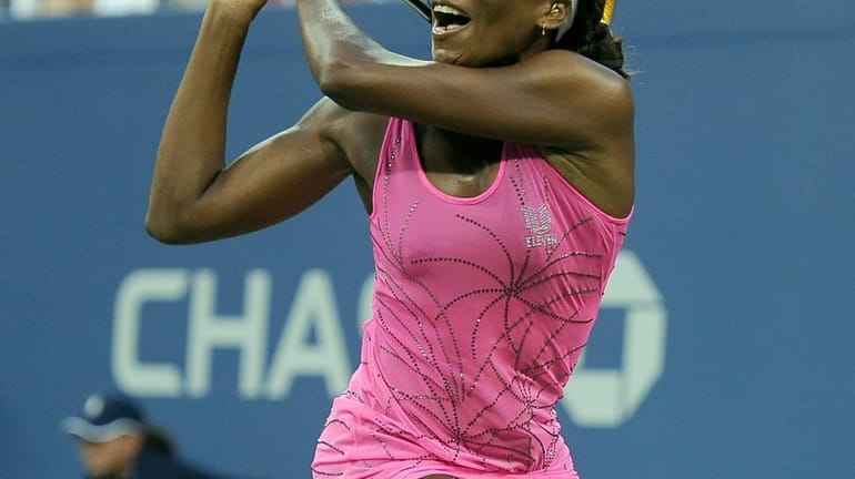 Venus Williams hitting a backhand against Francesca Schiavone in the...