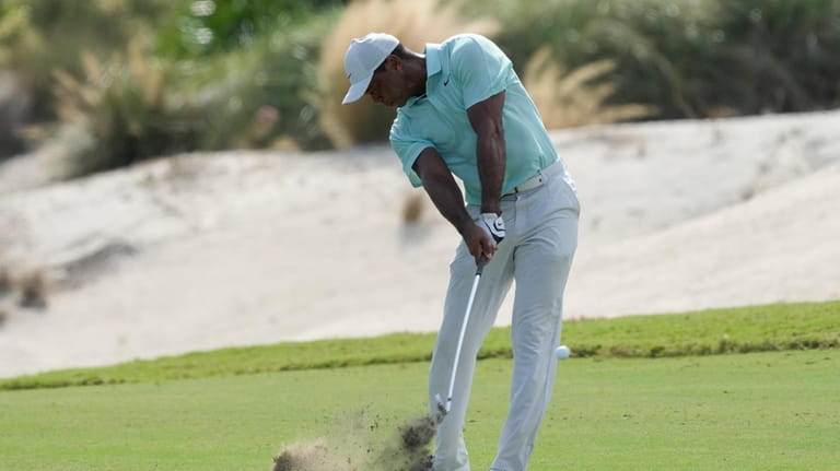 Tiger Woods hits from the third fairway during the third...