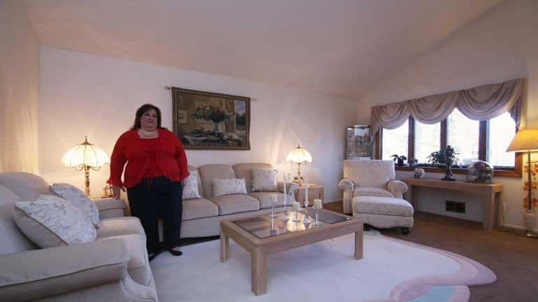 Donna Curcio stands in the living room of her home...