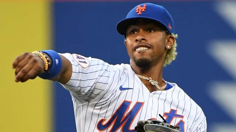 Mets shortstop Francisco Lindor throws before an MLB game against...