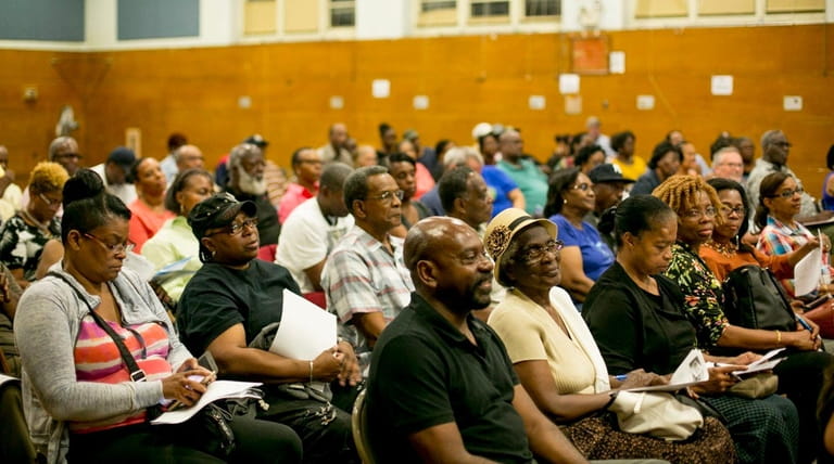 People attend a meeting on airplane noise in southern Queens,...