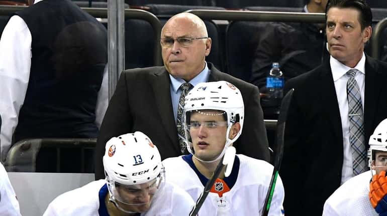Barry Trotz of the Islanders looks on against the Rangers during...