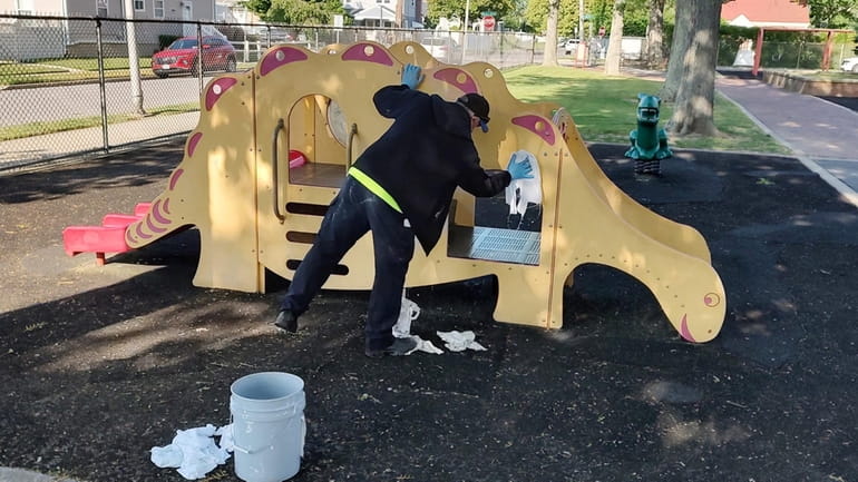 Graffiti is cleaned from playground equipment at Estella Street Park...
