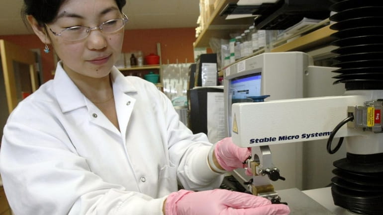 In this file photo, Lin Wang, a research assistant at...