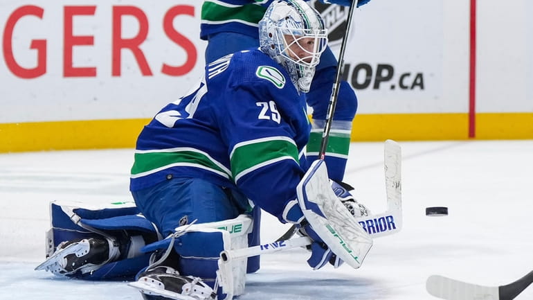 Vancouver Canucks goalie Casey DeSmith makes a save against the...