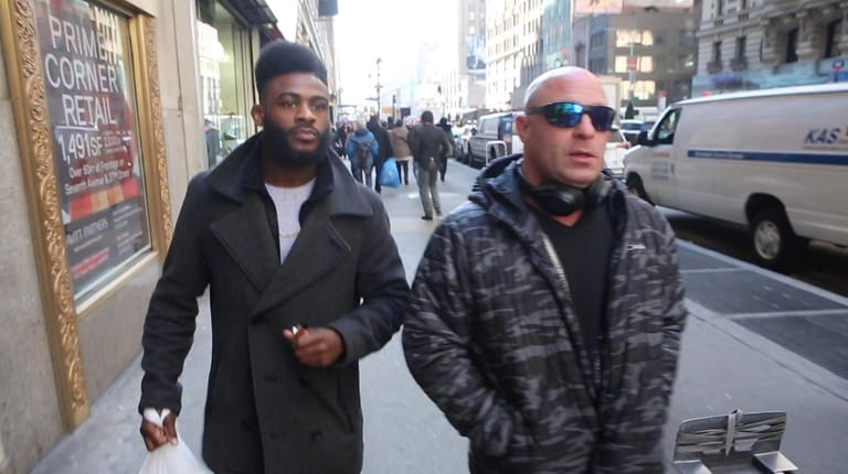 Sterling, left, walks with coach and "UFC Unfiltered" podcast co-host...