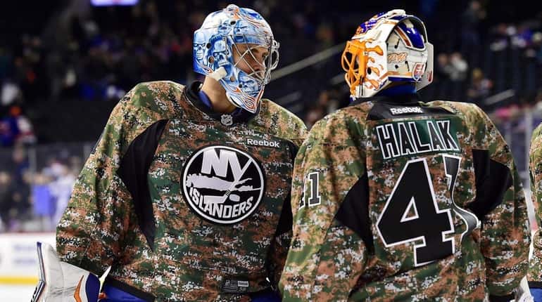 New York Islanders goalies Thomas Greiss, left, and goalie Jaroslav...