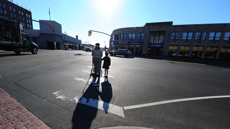 Pedestrians crossing at the intersection of Hempstead Turnpike and North...